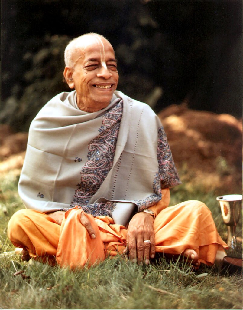 Srila Prabhupada seated outdoors